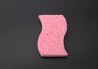 Pink sponge on a dark background.