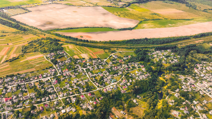 village settlement aerial view country side land along agriculture field in September autumn month time
