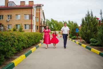 Happy well-dressed family on a walk. 