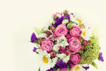 Closeup bouquet of flowers and one ring on the day of the engagement. Wedding day.