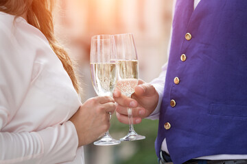 Close-up of a hand holding a glass of champagne. A loving couple on their wedding day.