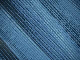 silver blue sunscreen in a car window protecting from summer sun with a rectangular grid and...