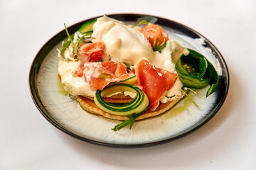 A Gourmet Dish Featuring Fresh Salmon, Creamy Sauce, and Colorful Vegetables Arranged on a Modern Plate with an Elegant Presentation.