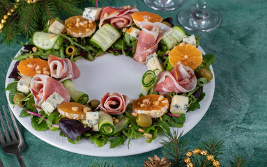 Wreath-shaped salad with jamon, tangerines, arugula, dor bleu cheese, cucumber and pine nuts