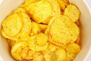 potato chips with spices in a bowl. 