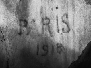 "Paris 1918" written with black ink on a wall of a cavern
