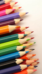 Fototapeta premium Close-up macro photograph of sharpened multicolored colored pencil tips arranged tightly with vibrant pigments and soft lighting, showcasing texture and symmetry for creative and education visuals