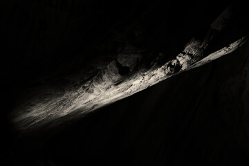 natural stone formation of a ceiling in a cave looking like a long isolated stone