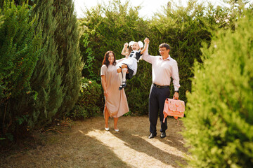 A family in the garden sees off daughter on first day of school
