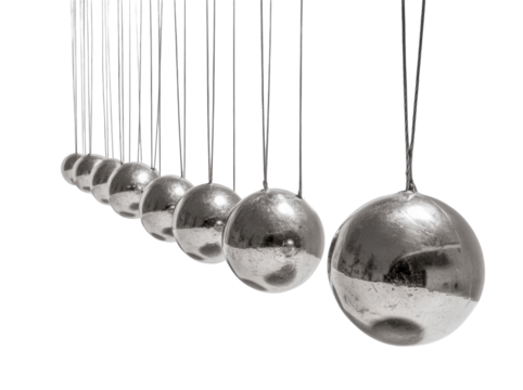 Dynamic Newton's cradle spheres reflect light, showcasing physics principles and modern design in motion