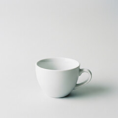 White cup with coffee or tea placed on black background