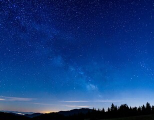 Fototapeta premium A majestic view of the night sky filled with countless stars above the landscape
