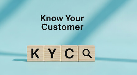 KYC know your customer concept with wooden blocks and magnifying glass on blue surface representing identity verification financial regulation and compliance

