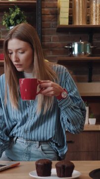 A focused woman is diligently working on her laptop in a cozy and comfortable environment