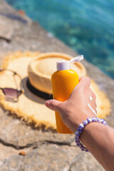 Sunscreen against the sea. Selective focus.
