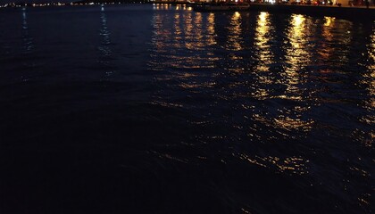City lights reflected on dark water