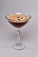 A Captivating Cocktail with Rich Brown Tones and Creamy Foam Topped with Coffee Beans, Perfectly Served in a Classic Martini Glass