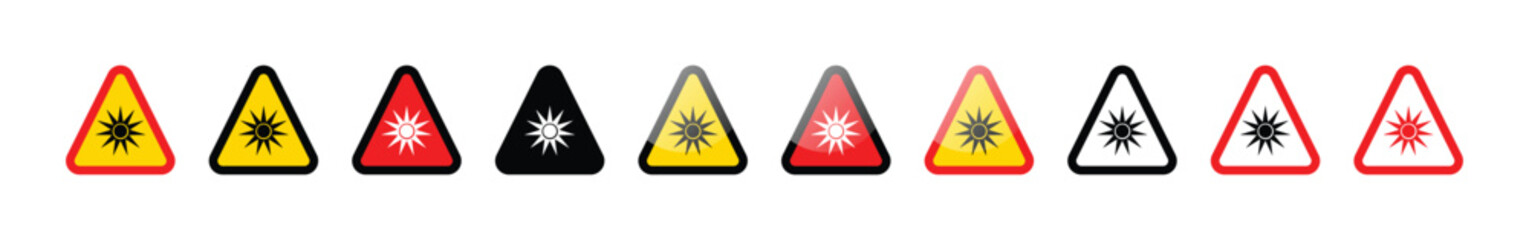 A row of laser hazard warning signs in various colors on a white background
