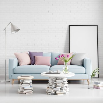 Cozy living room interior with a light blue sofa and book-stack side tables.
