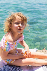 The child has sunscreen on his face. Selective focus.