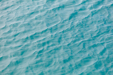 The image is of a body of water with ripples and waves