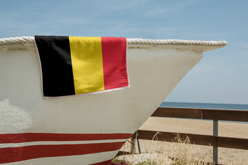Beach Towel Draped Over A Boat with the flag of Belgium 3D Rendering