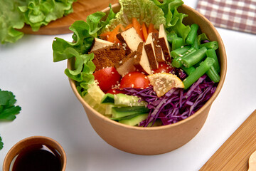 Colorful Salad Bowl with Fresh Vegetables and Tofu in a Natural Container, Perfect for Health-Conscious Eating and Nutrient-Rich Meals