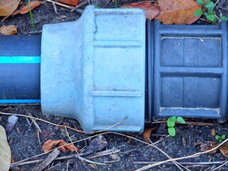 Plastic fastening for the garden watering hoses. Close-up.
