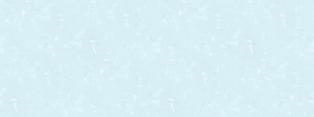 A light blue textured background with a mottled or speckled appearance.