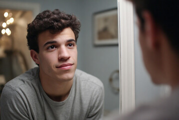 Candidate practicing speech in mirror, focused expression, soft interior lighting.