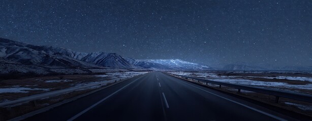 The Serene Night Road Leading Through Majestic Snow-Capped Mountains.