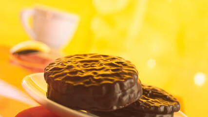 Two chocolate pastries on a background of a coffee cup.