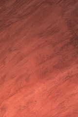 Rough red plaster on a house wall.