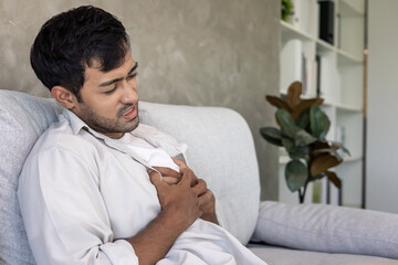 hand hold chest with heart attack symptoms, asian man have chest pain caused by heart disease,...