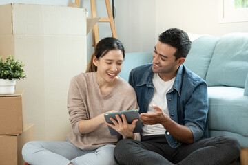 Moving house, relocation. Couple choose design for building new apartment, inside the room was a...