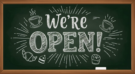 We're Open chalk lettering on a green blackboard. Hand-drawn cafe sign with coffee cups and pastries for business.