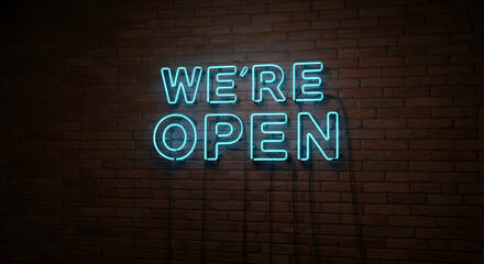 Vibrant blue 'We're Open' neon signage with a glowing light effect mounted on a vintage brick wall