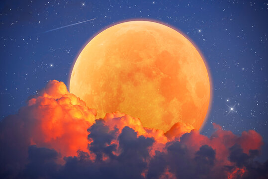 Fantastic astrological background with an orange moon emerging from red clouds, a beautiful full moon with stars and sky