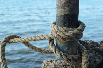 Rope is tied around a post near the water