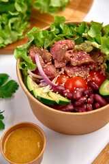 Fresh and Colorful Salad Bowl Packed with Lean Meat, Vegetables, and a Flavorful Dressing for a Nourishing Meal Experience
