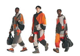 Three young men walking with sports bags, basketballs in hand, isolated on a transparent background