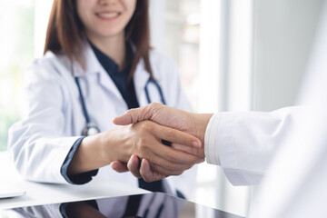 Handshake, asian medical doctors shaking hands have agreement on patient health, illness treatment...