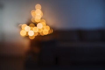 Blurre background of room with illuminating christmas tree in the evening