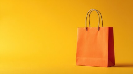Orange paper shopping bag on yellow background