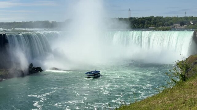 Tour boat heading into Horseshoe Falls the largest of the falls at Niagara Falls on the United States and Canada Border
