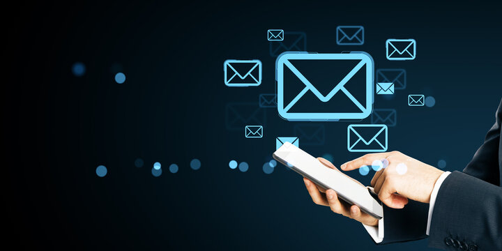 Businessman using smartphone with floating digital email icons on dark background representing online communication and messaging concept. - Powered by Adobe