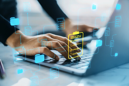 Hands typing on laptop with digital document icons representing online document management system and workflow solution in an office setting.