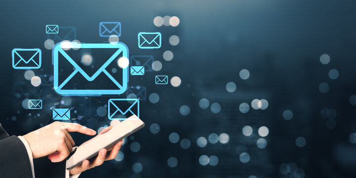 Person using tablet with glowing email icons in digital interface on dark background representing online communication and messaging concept. - Powered by Adobe