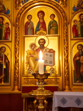 Golden Icon lamp. Golden lampad in front of the icons in the Orthodox Church. Lampad in the church, a burning candle. Orthodox icons in the church. religious concept. Gilded church altarpieces.
