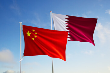 flags of china and qatar flags over blue sky background.